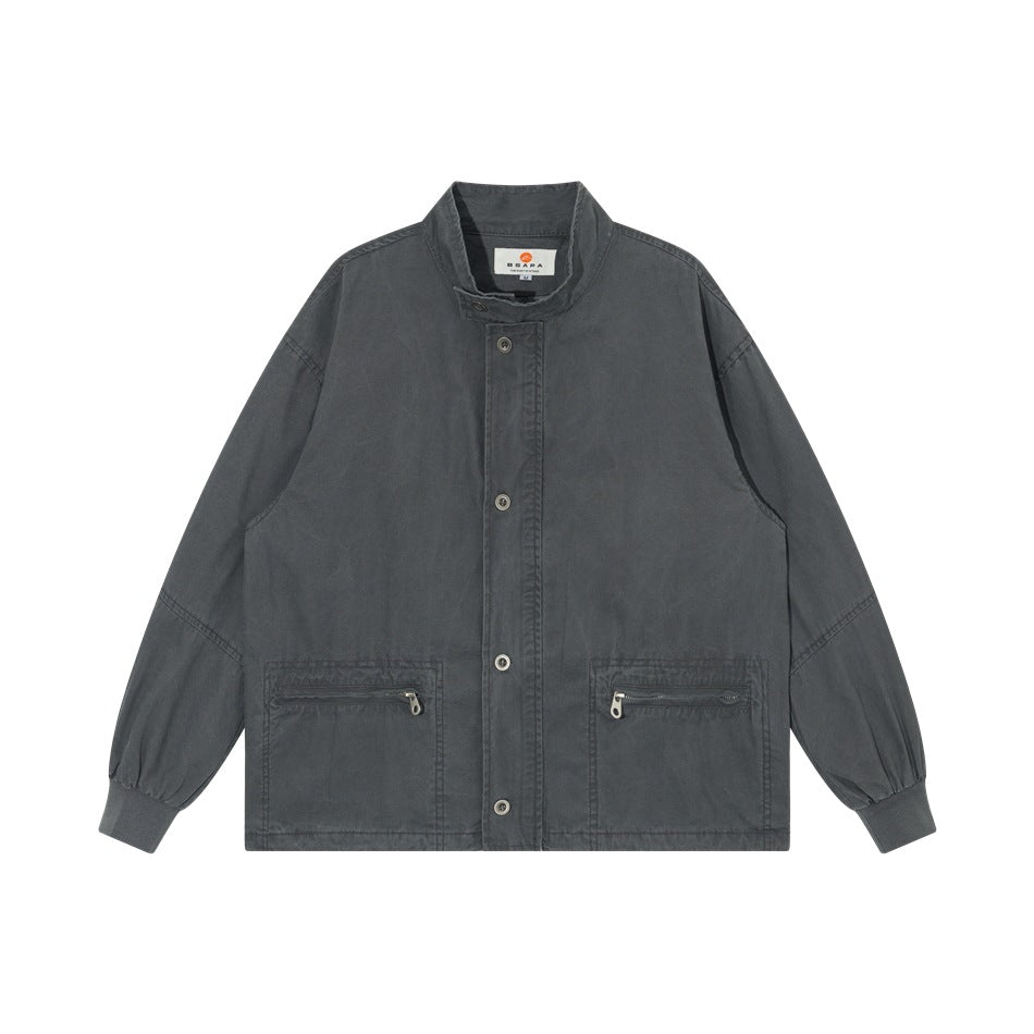 Dark gray washed-look stand-collar jacket with button front, zippered pockets and ribbed cuffs, flat lay