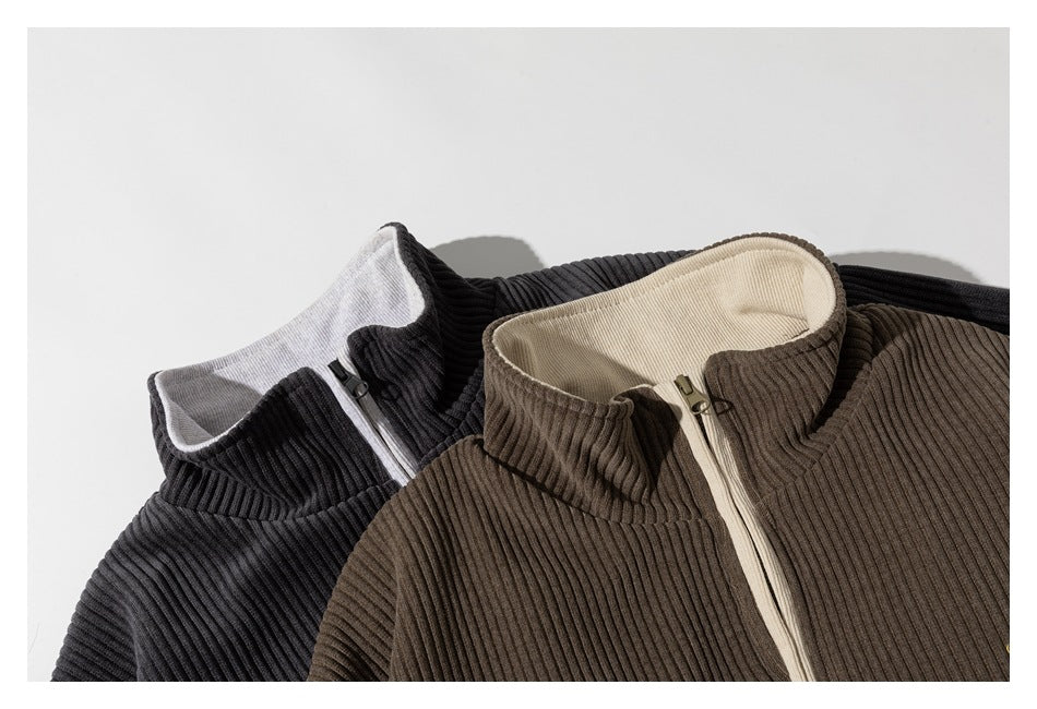 Close-up of black and taupe ribbed jacket collars and contrasting zipper details.