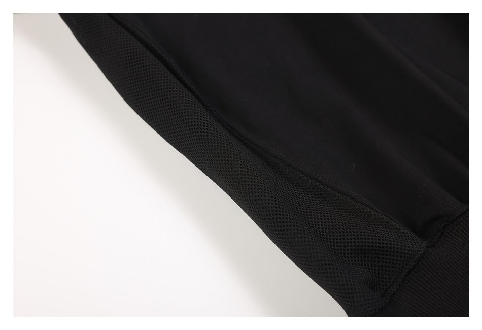 Close-up showing the black sweatshirt's mesh side panel and seam.