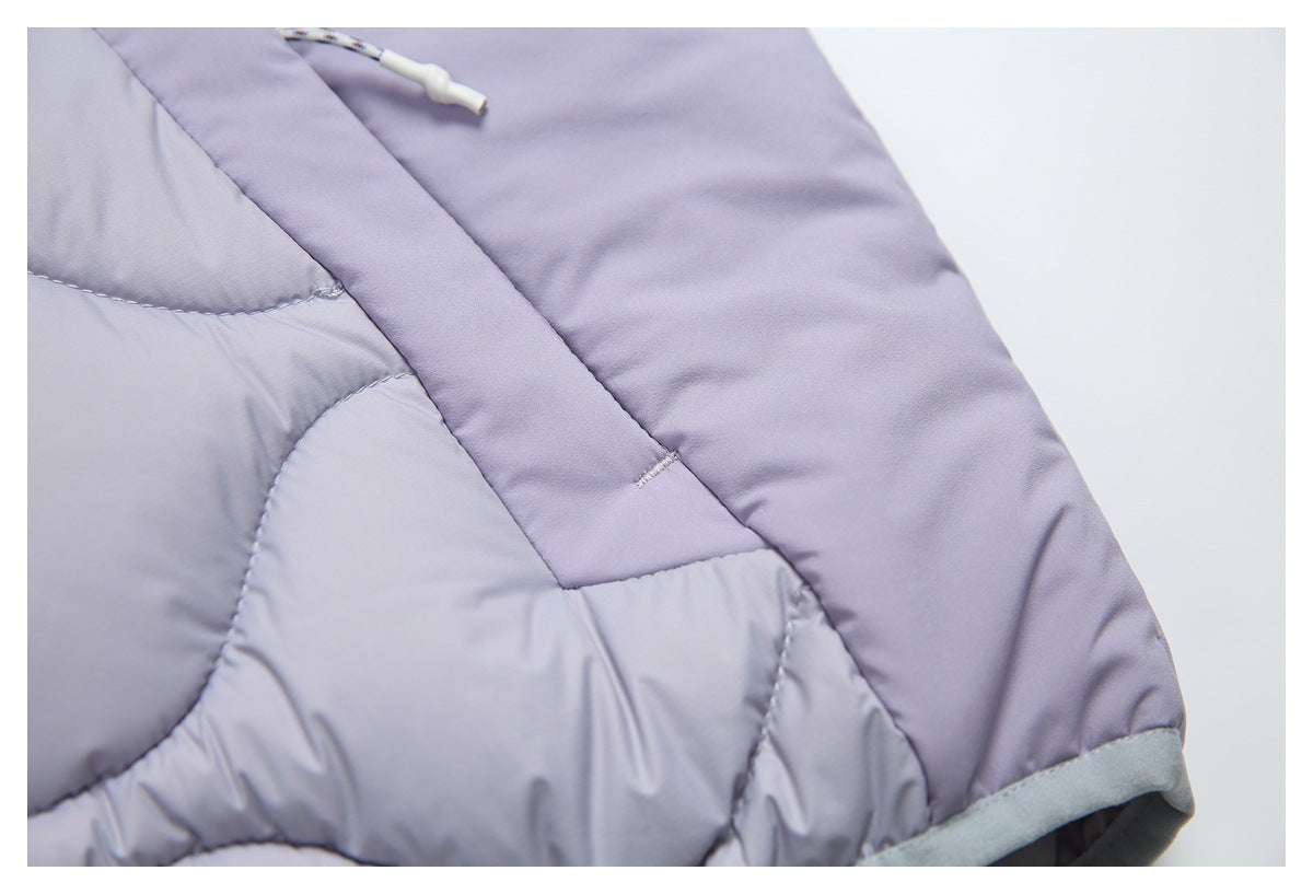 Close-up of lavender quilted fabric, a cord pull, and gray trim at the garment edge.
