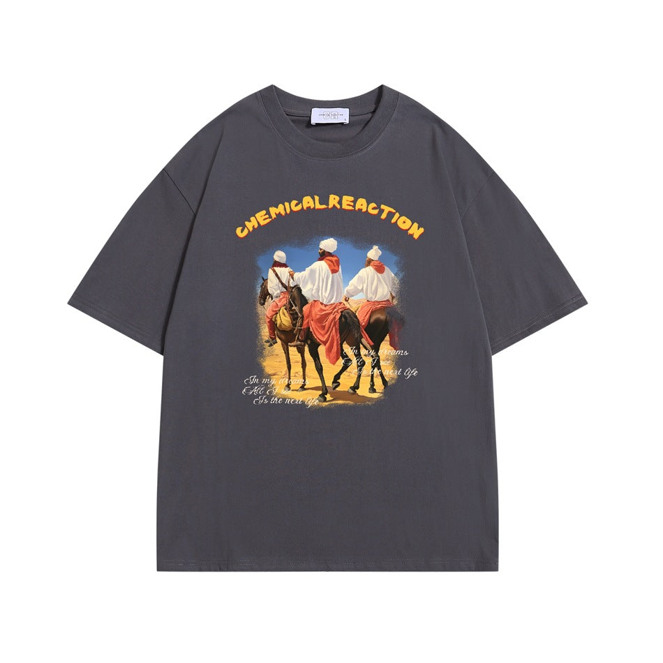 Dark gray short-sleeve T-shirt with desert riders on horseback print and yellow CHEMICAL REACTION arched text