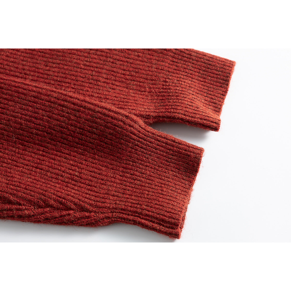Close-up of the rust-red sweater’s long ribbed sleeves and cuffs.
