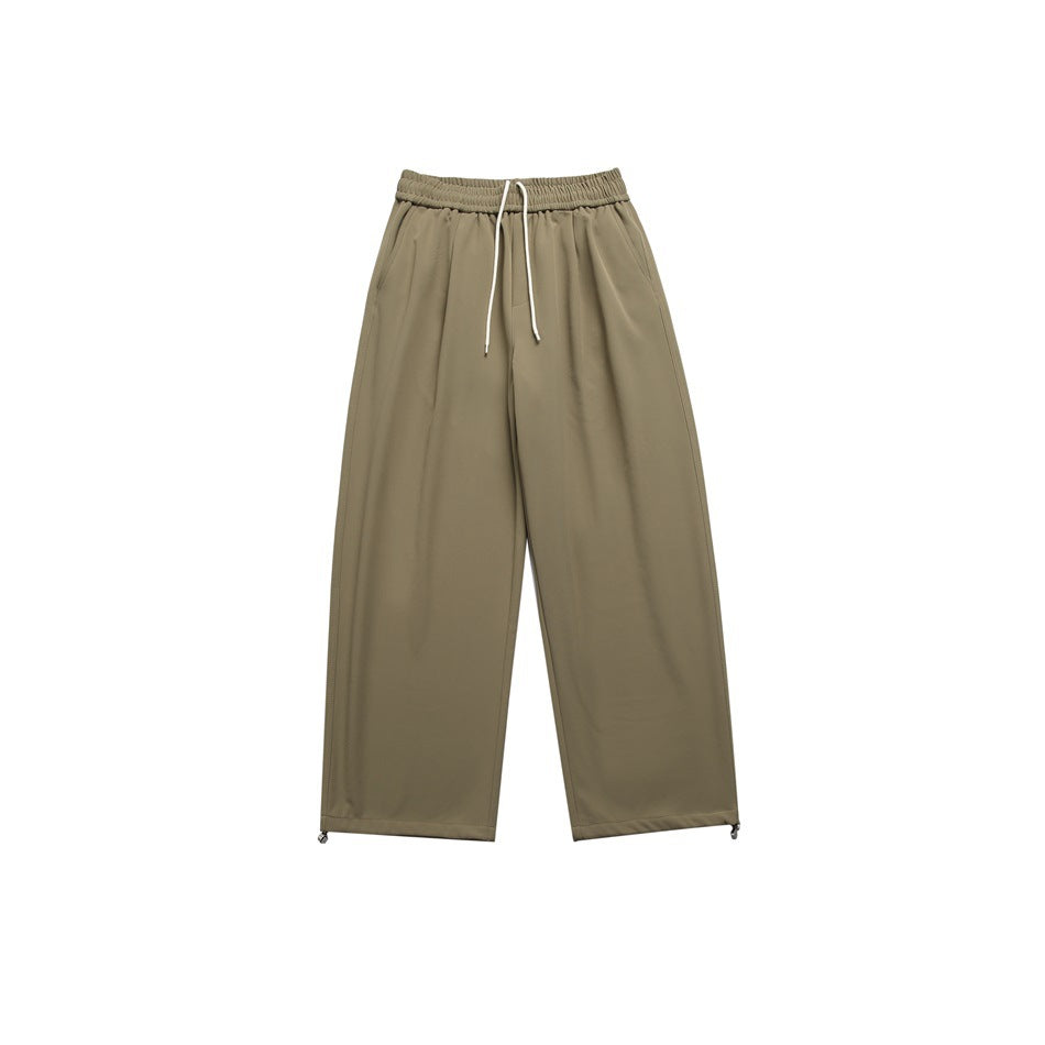 Army green wide-leg pants with elastic drawstring waist, front pleats and hem toggles, flat lay front view