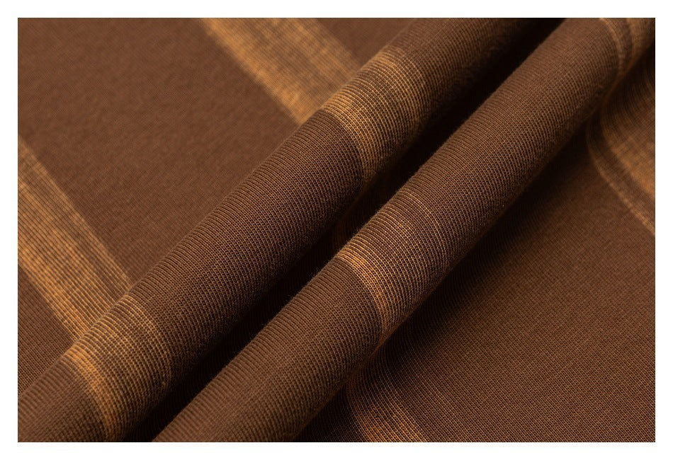 Close-up showing the brown striped garment fabric draped to reveal its texture.