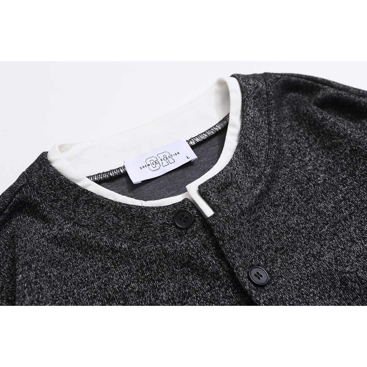 Close-up of a charcoal heather long-sleeve top showing its white-trimmed neckline, button placket, and neck label.