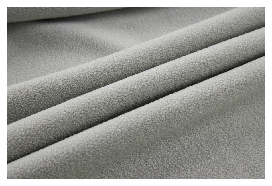 Close-up of textured gray fabric draped in overlapping folds.