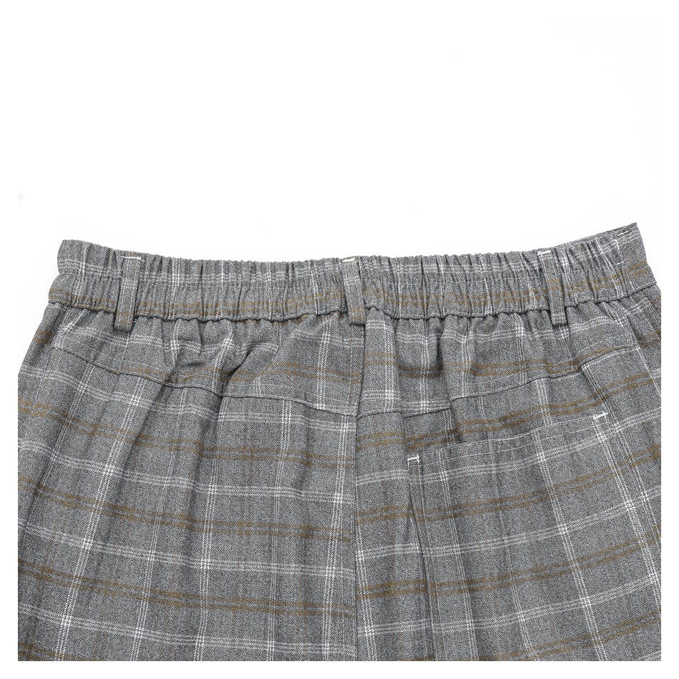 Cropped back view of gray plaid trousers showing an elasticized waistband, belt loops, and a rear pocket.