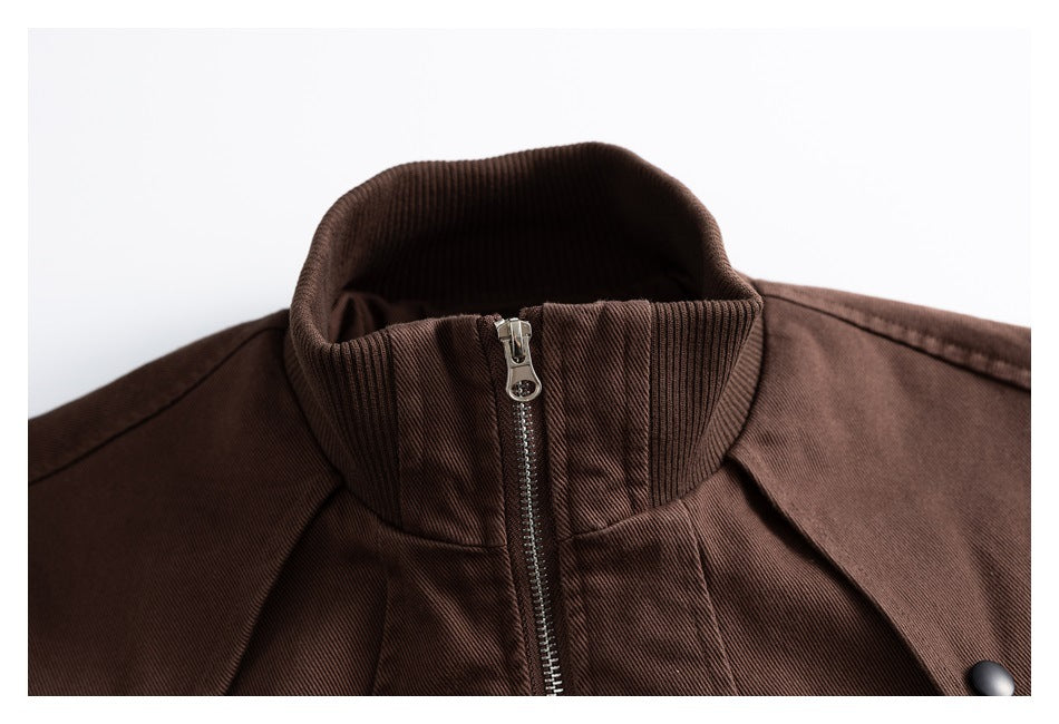 Close-up of a brown jacket’s ribbed stand collar and metal front zipper.