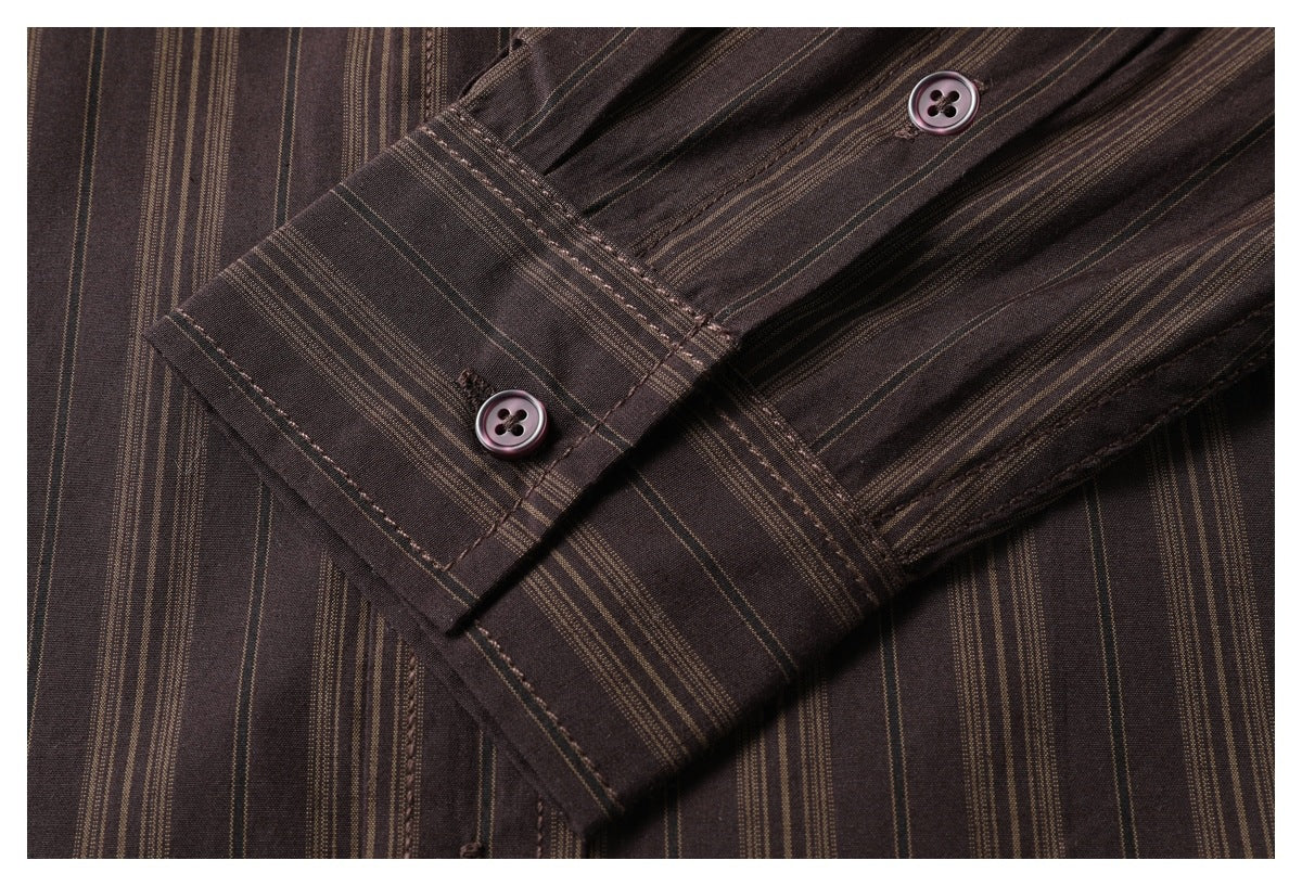 Close-up of the striped shirt's buttoned cuff and sleeve.