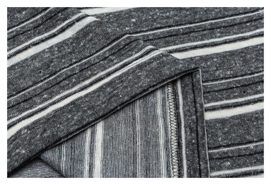 Close-up of a folded seam showing the inside and overlocked edge of charcoal gray striped fabric.