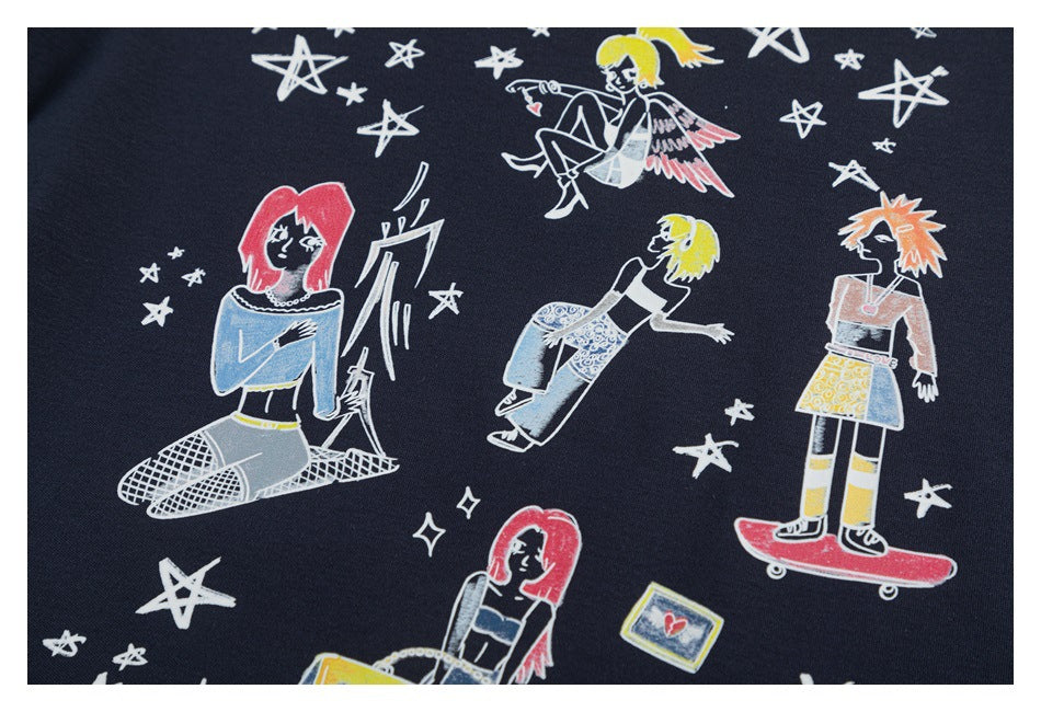 Close-up of the shirt's colorful character artwork, featuring illustrated figures and white stars on navy fabric.