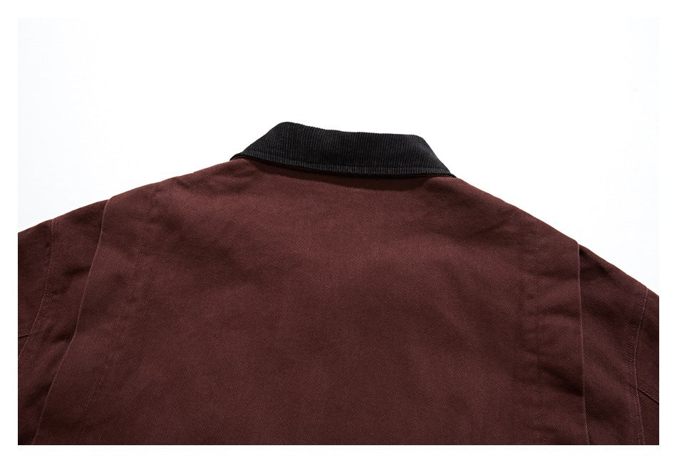 Upper back of a burgundy jacket with a contrasting black collar.