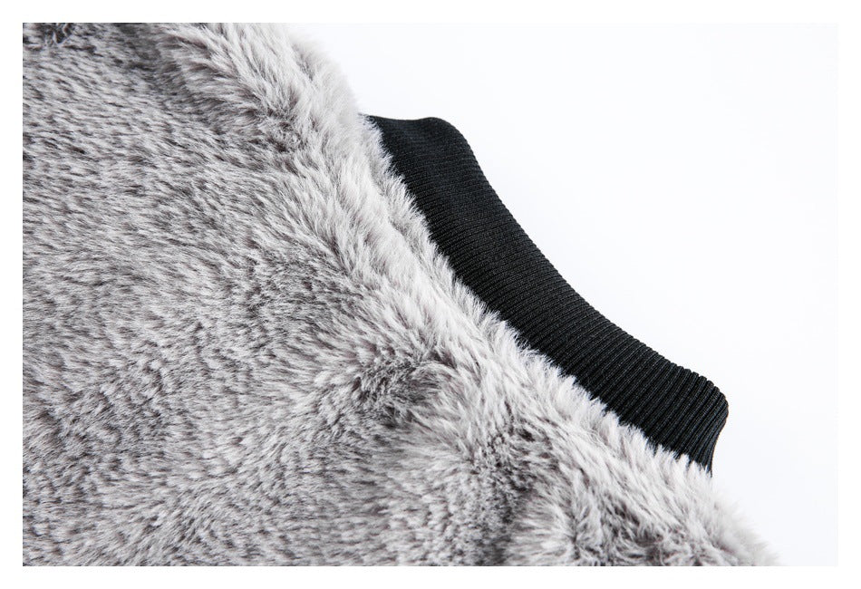 Close-up of gray faux fur beside a black ribbed collar or trim.