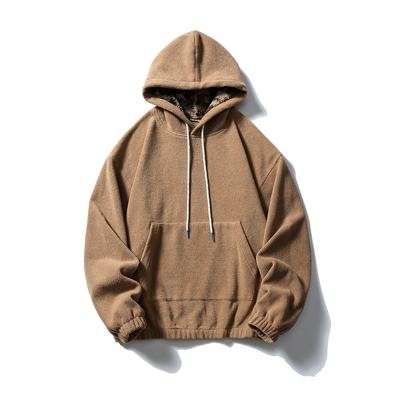 Khaki fleece-like pullover hoodie with kangaroo pocket, white drawcords and camouflage-patterned hood lining, flat lay