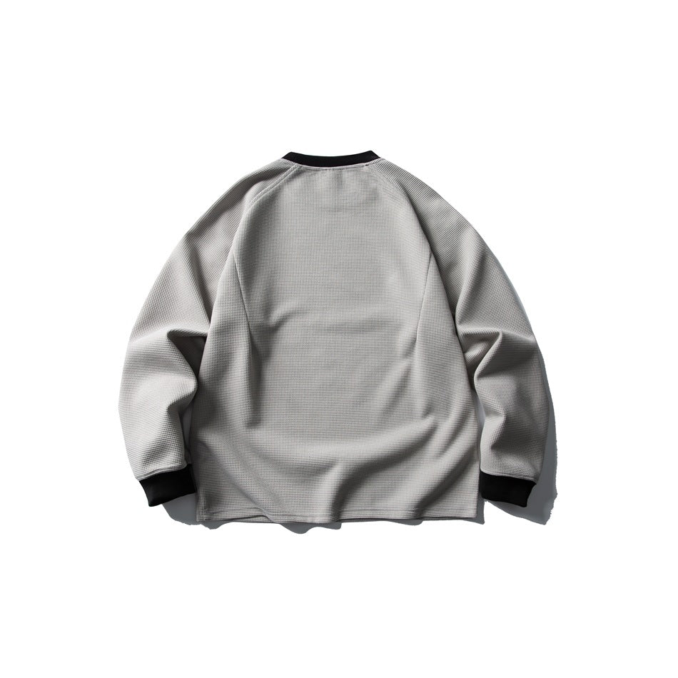 Back view of a light gray textured crewneck sweatshirt with black ribbed collar and cuffs.
