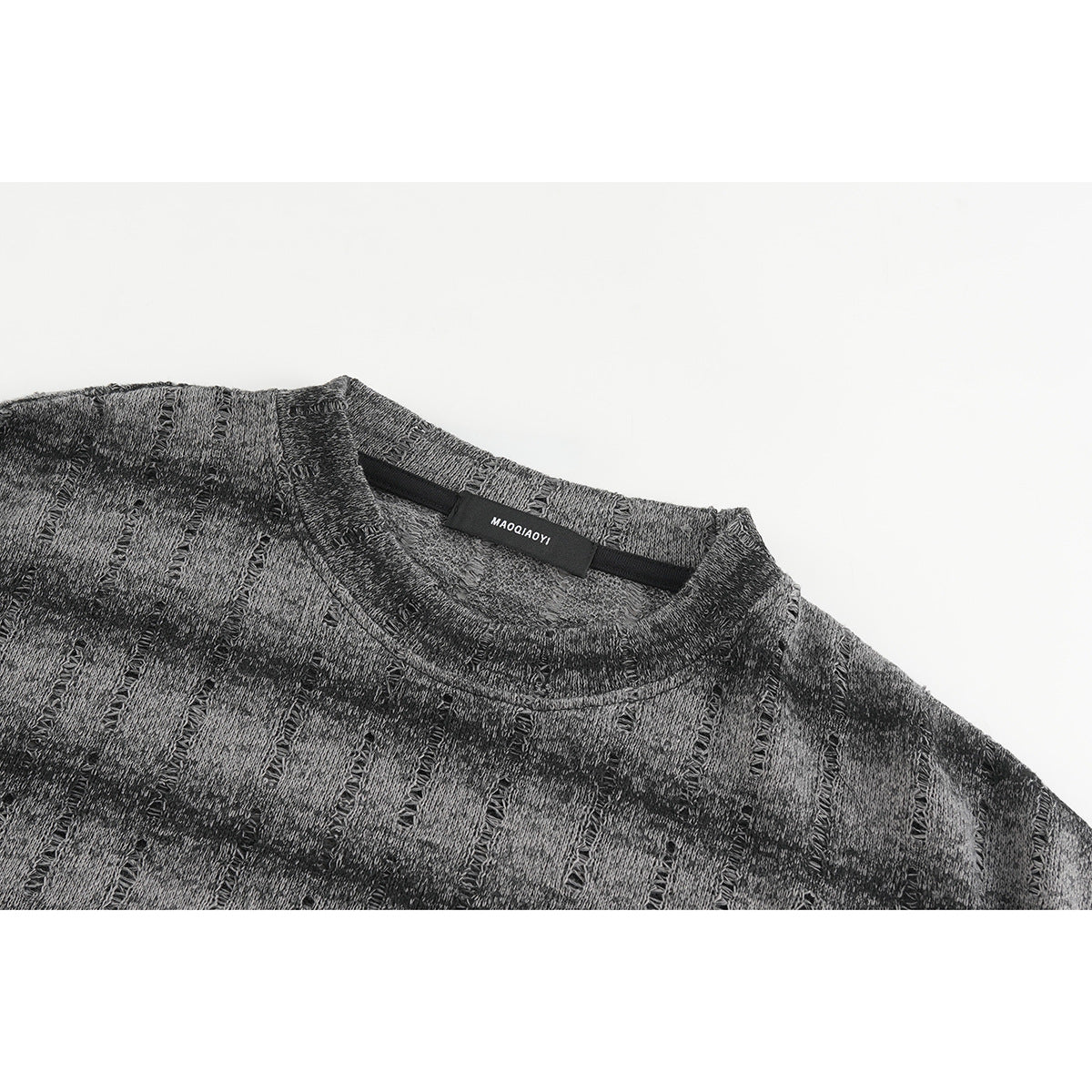 Close-up of a charcoal gray patterned crewneck shirt showing the neckline and inner label.