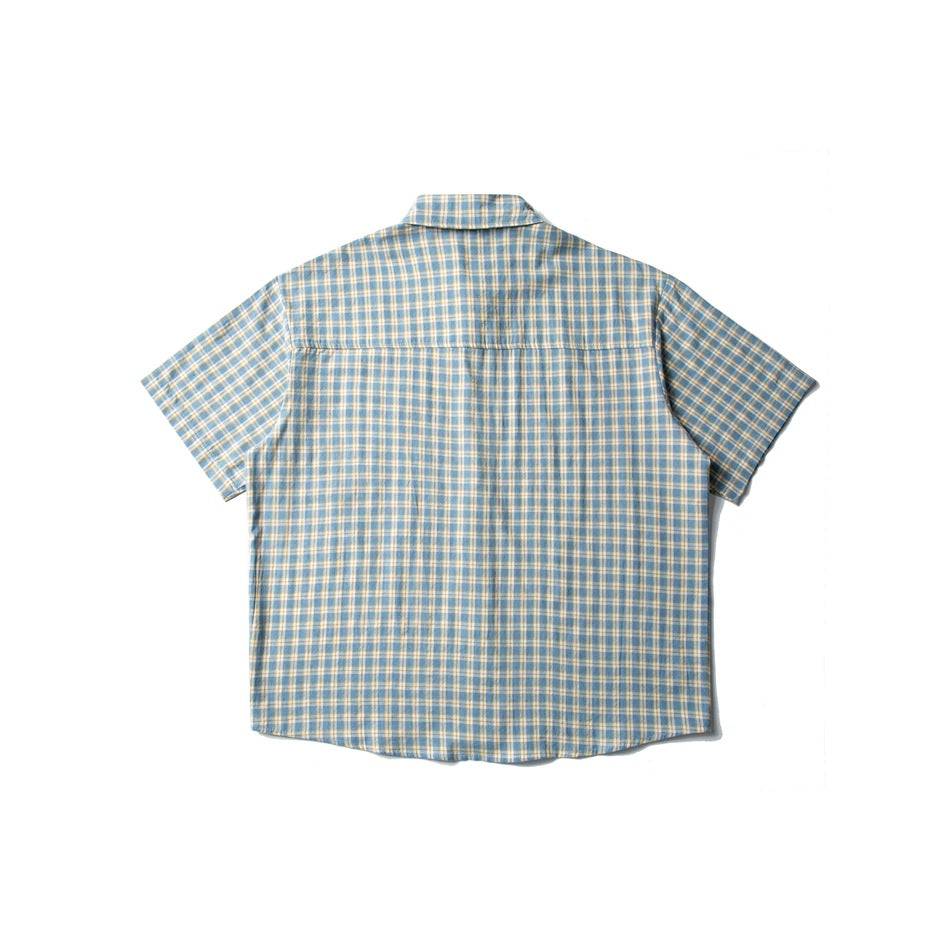 Back view of a short-sleeve button-up shirt in blue, white, and mustard plaid, laid flat on white.