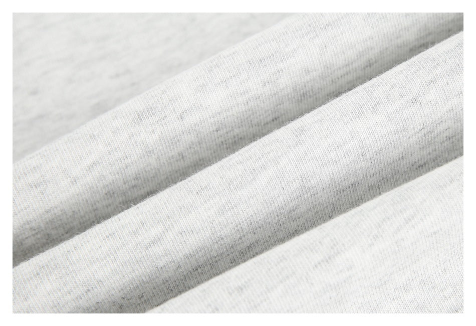 Close-up of light gray heathered fabric draped in soft folds.