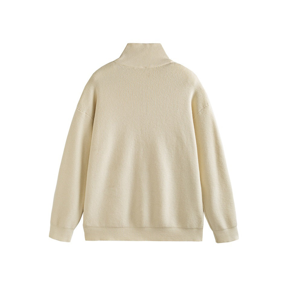 Back view of a light cream ribbed sweater with a high collar, long sleeves and ribbed hems.