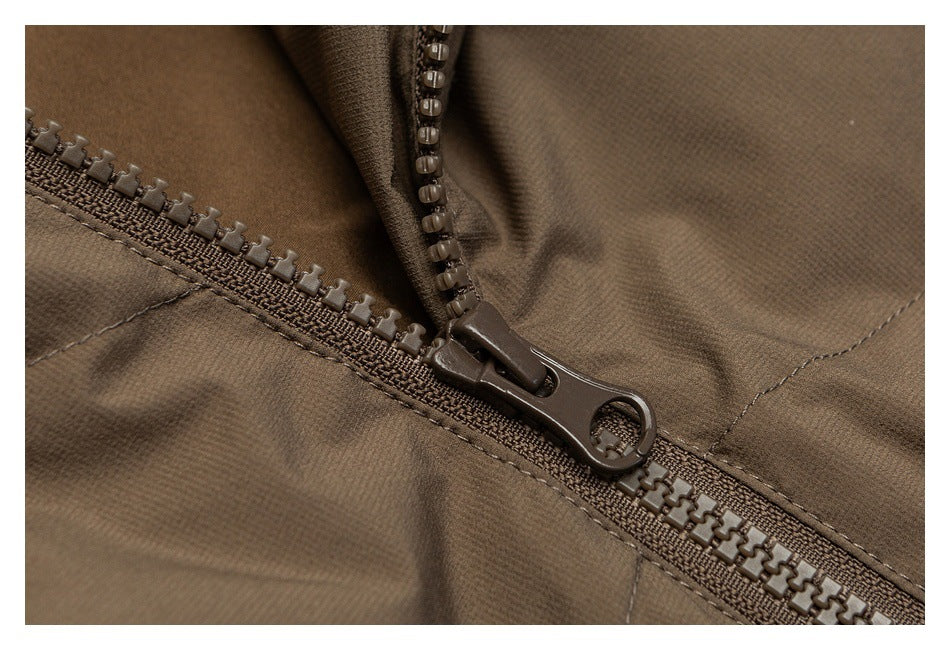 Close-up of a brown jacket's chunky front zipper and stitching.
