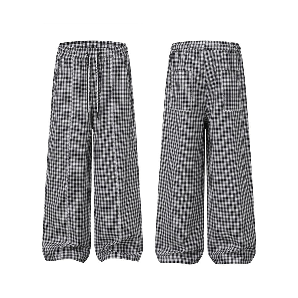 Isolated black-and-white checked pants shown from the front and back, with an elastic waist, drawstring, and back pockets.