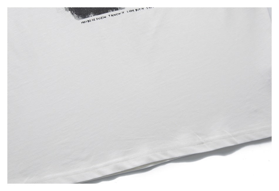 Close-up of the white T-shirt hem with a small, partially visible black printed graphic and text.