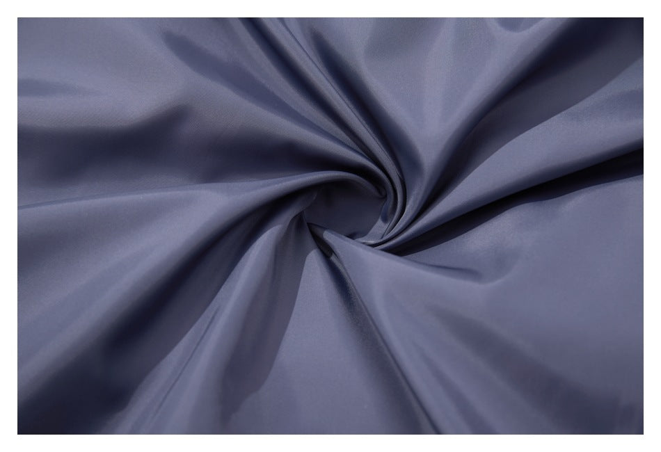 Close-up of smooth slate-blue fabric draped into folds.