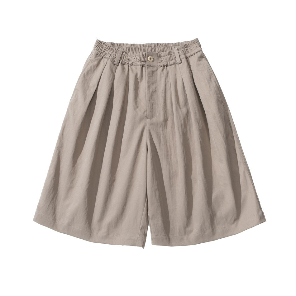 Khaki beige wide-leg knee-length shorts with pleats and double elastic waistband, flat lay front view