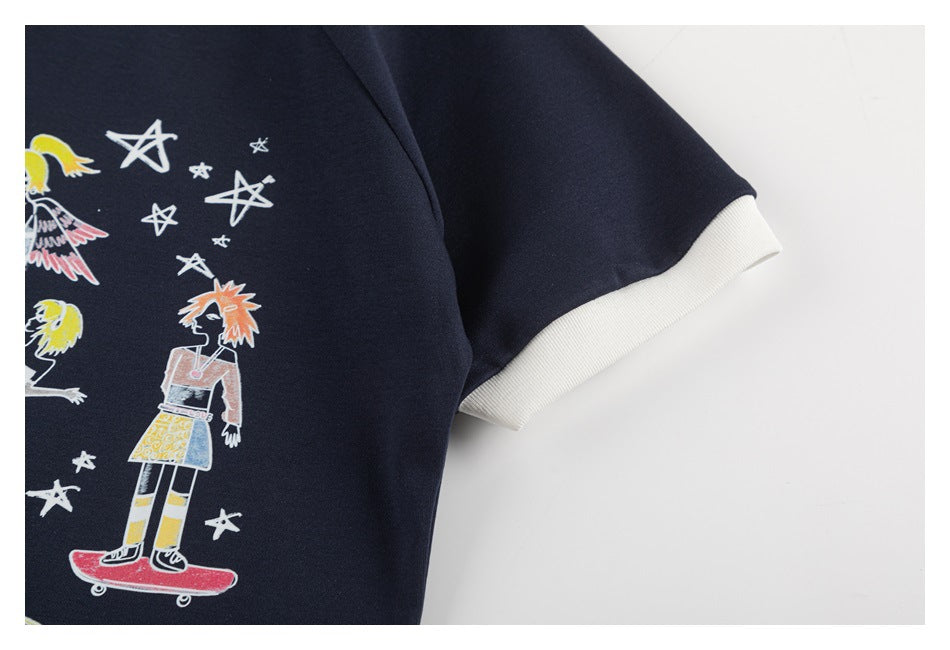 Close-up of a navy garment with white ribbed sleeve trim and colorful illustrated figures and stars.