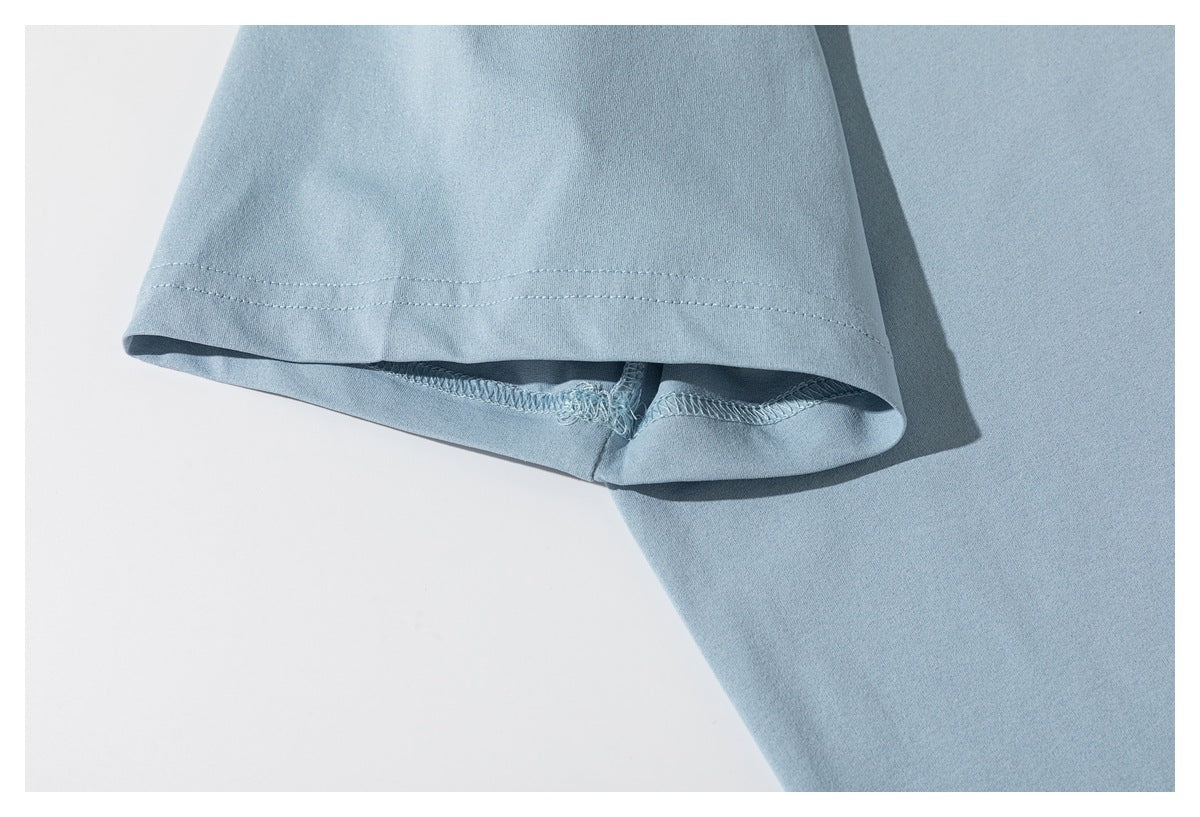 Close-up of the sleeve hem and stitching on a light blue T-shirt.