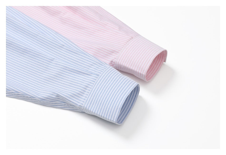Close-up of blue- and pink-striped shirt sleeves with matching button cuffs.
