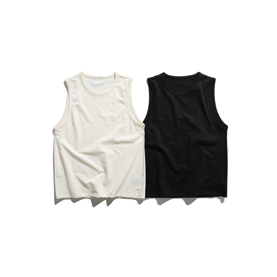 Front view of two sleeveless tank tops laid flat, one cream and one black.