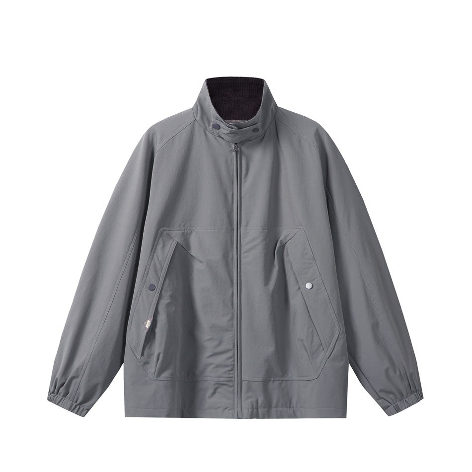 Blue-gray zip jacket with stand-up snapped collar, front pockets and elastic cuffs, flat front view