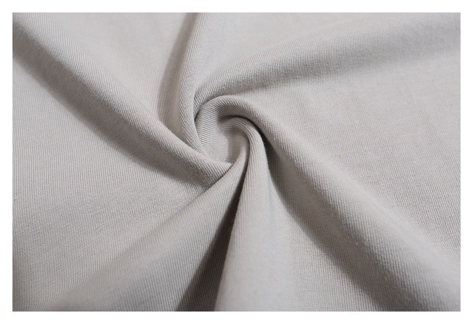 Close-up of light gray fabric gathered into a twist, showing its knit texture.