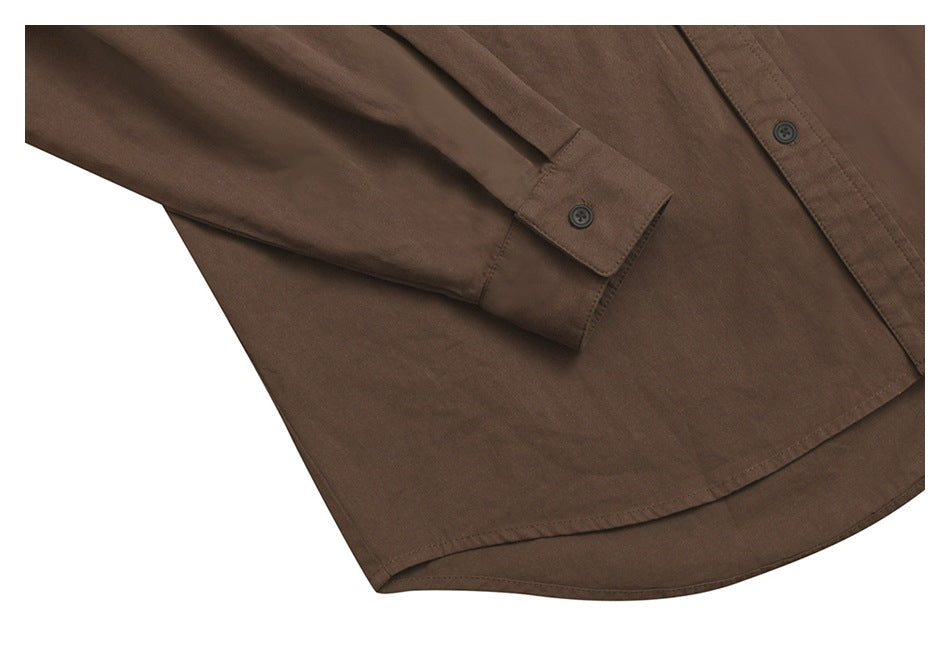 Close-up of a brown button-up shirt showing its sleeve cuff, dark buttons, and curved hem.
