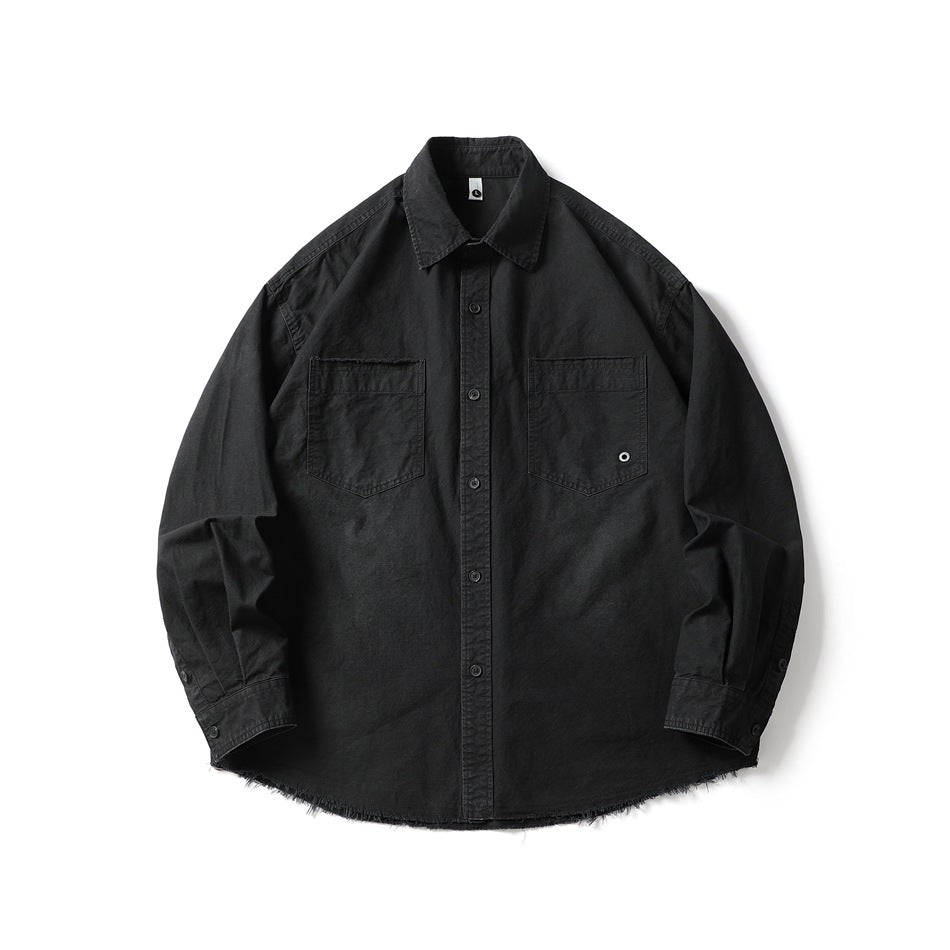 Black long-sleeve button-front shirt with two chest pockets and frayed raw hem, flat lay