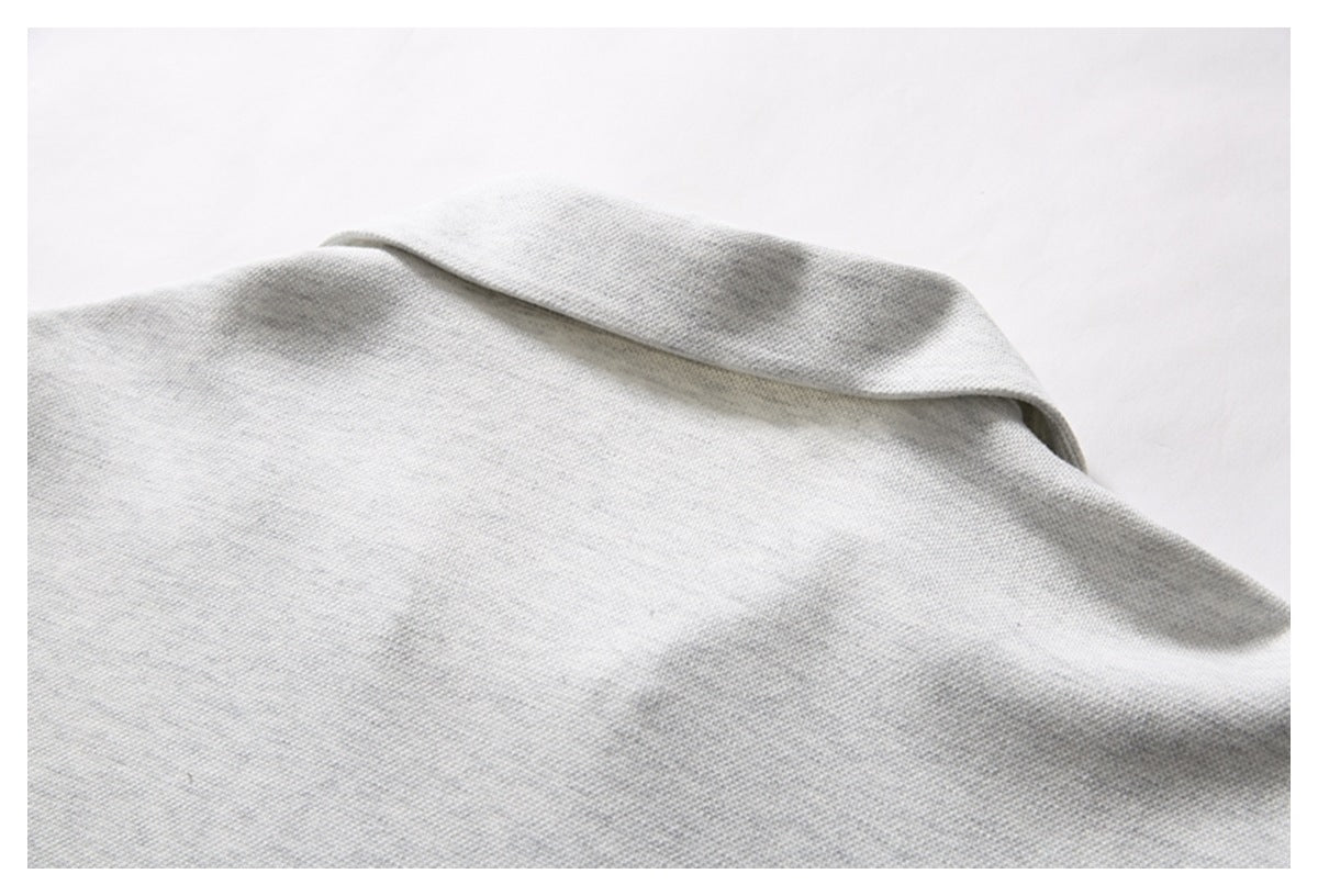 Close-up of the light gray shirt's back collar and shoulder seam.