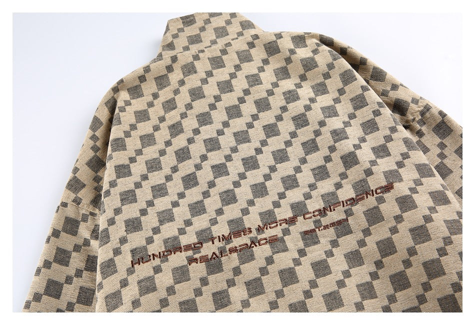 Partial back view of a beige and charcoal check jacket with brown embroidered English lettering.
