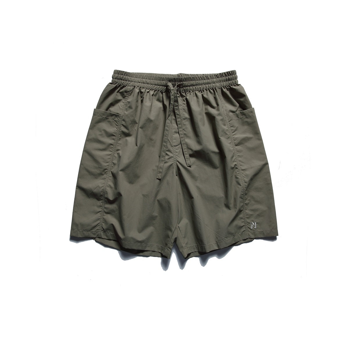 Khaki olive shorts with drawstring waistband, large side patch pockets and small embroidered N logo, flat lay