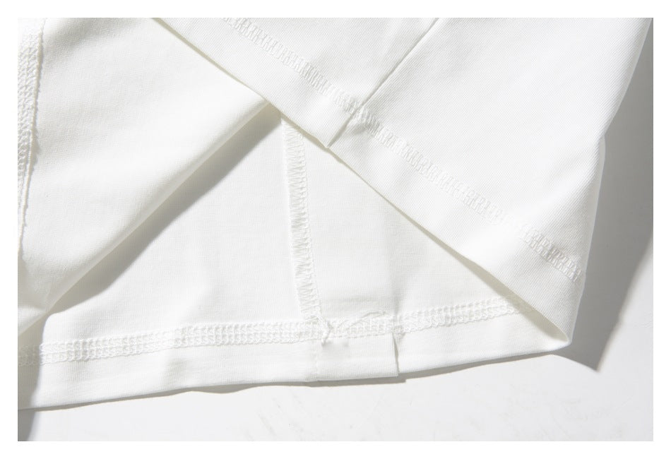 Close-up of the white shirt’s folded fabric and overlocked interior seams.