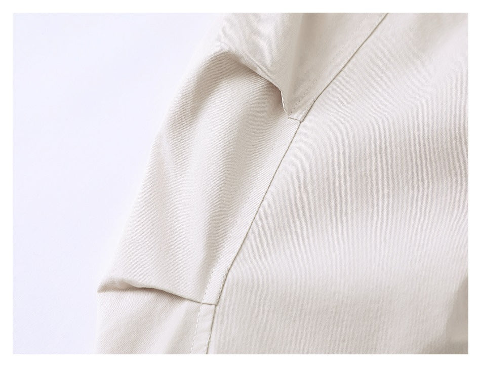 Close-up of a beige jacket shoulder and sleeve seam.