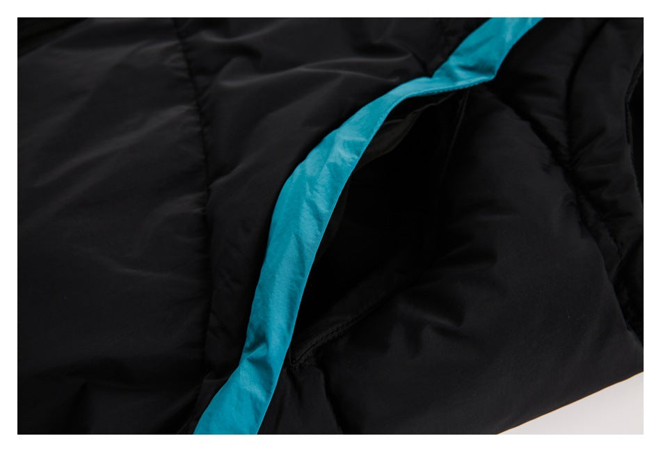 Close-up of black padded garment with a bright turquoise strip bordering an opening.