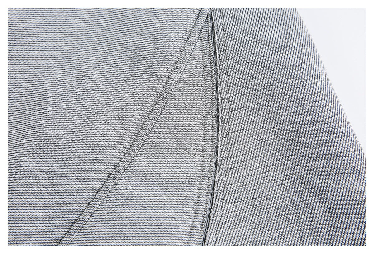 Close-up of black-and-white striped fabric and a neatly stitched seam.