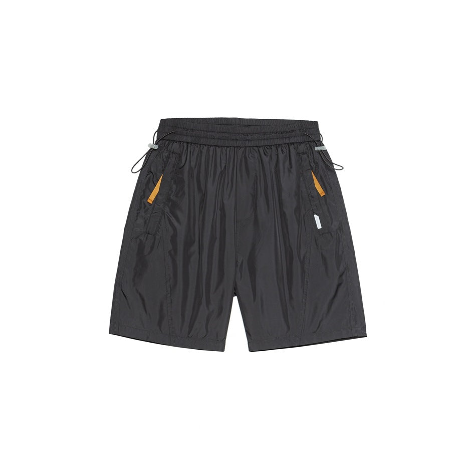 Dark gray knee-length shorts, front flat view, with elastic waist, side drawcord toggles and orange pocket accents