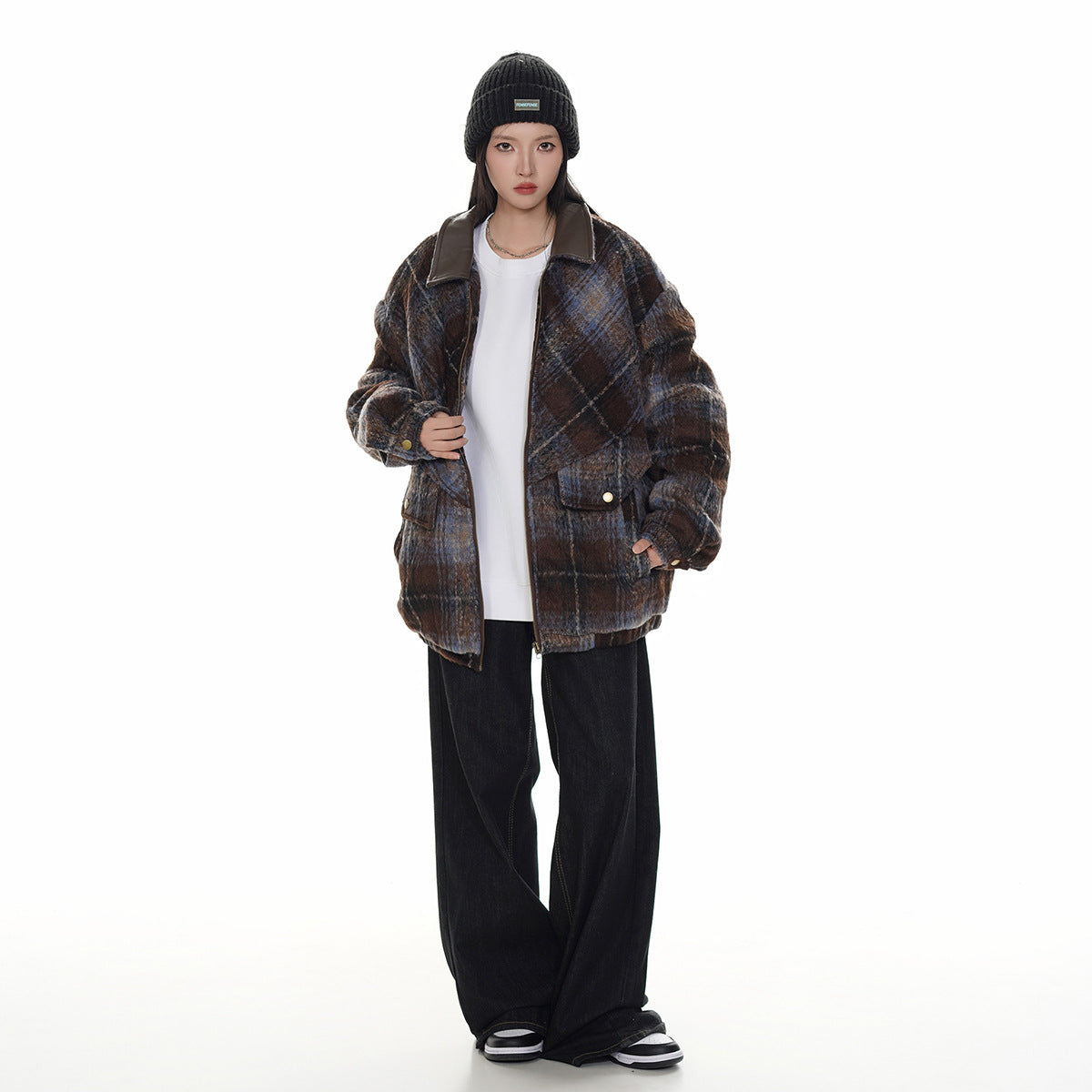 Full-length model wearing a brown and blue plaid jacket with a dark collar and front pockets.