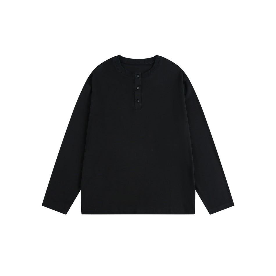 Front view of a plain black long-sleeve top with a ribbed crew neck and three-button placket.
