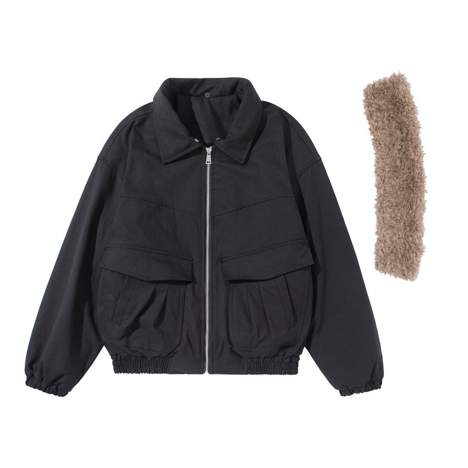 Front view of a black zip jacket with a pointed collar, large flap pockets and a separate shaggy tan collar piece.