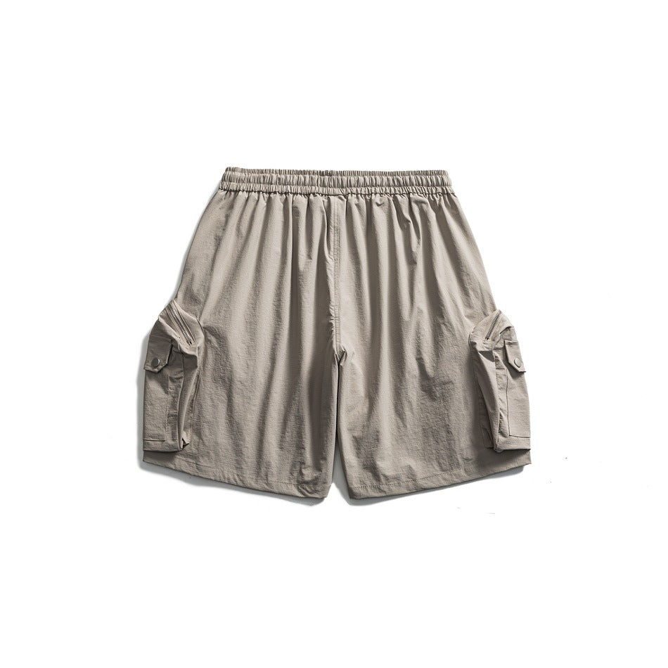 Back view of light beige cargo shorts with an elastic waistband and flap pockets on both sides.