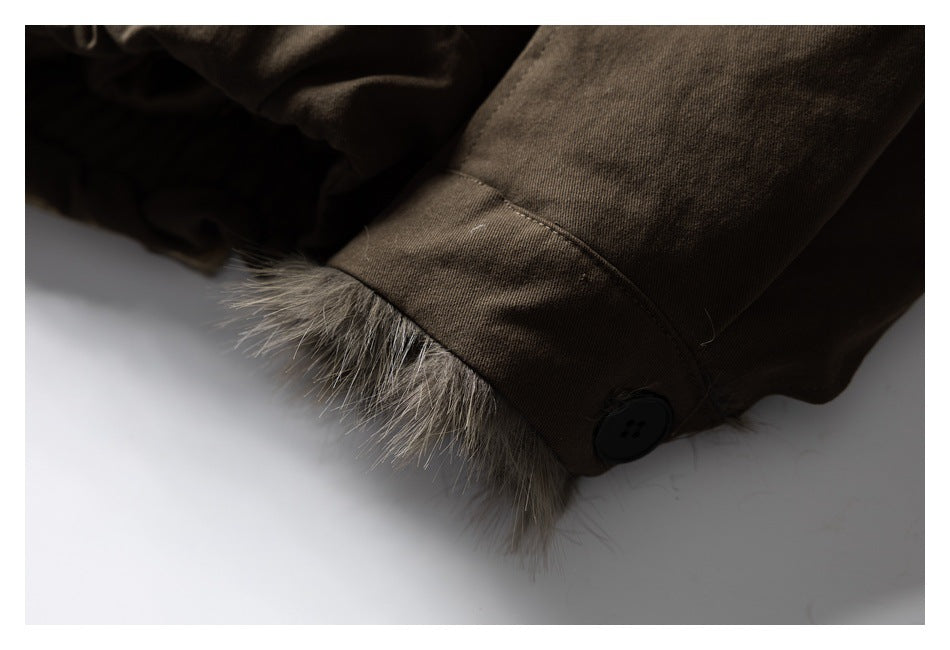 Close-up of a brown coat sleeve cuff with fur edging and a dark button.