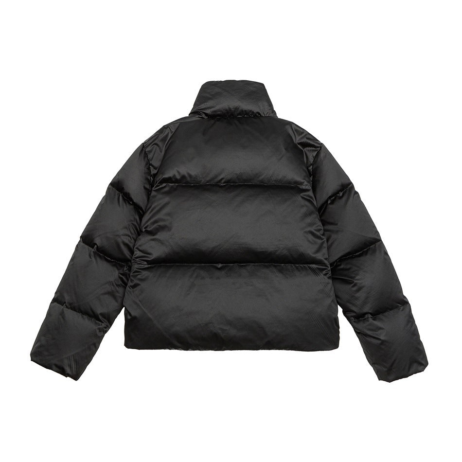 Back view of a black puffer jacket laid flat, with a high collar and horizontal quilted sections.